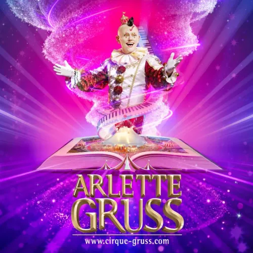 Cartel del circo Arlette Gruss con un payaso de traje colorido emergiendo de un libro mágico abierto, rodeado de efectos de luz rosa y púrpura, con el logo y sitio web del circo en la parte inferior.